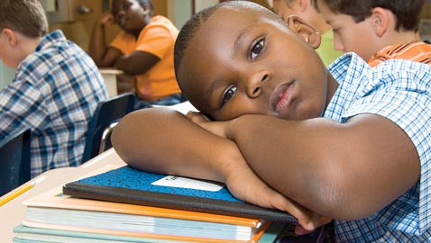 black-boy-with-head-on-desk